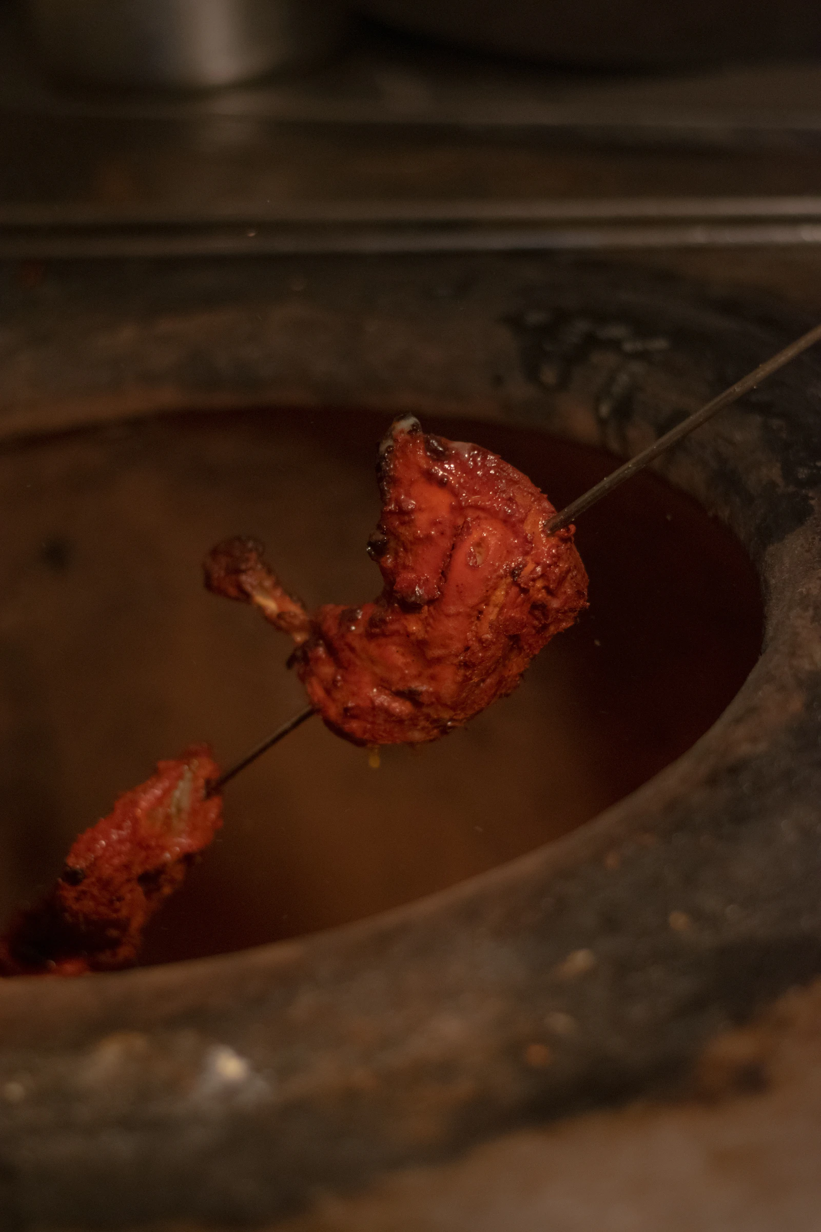 A sealed pot cooking over live fire