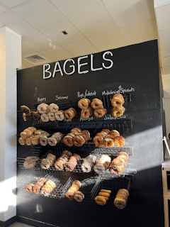 Warm morning light filters through the windows of brightbagel, casting a golden glow on shelves stacked with fresh, hand-rolled bagels.
