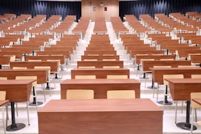 a room filled with lots of wooden desks