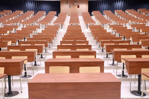 a room filled with lots of wooden desks