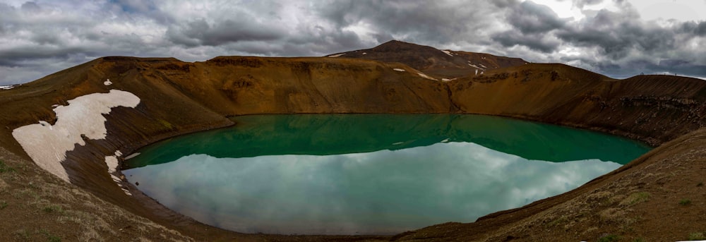 a large crater with a lake in the middle of it