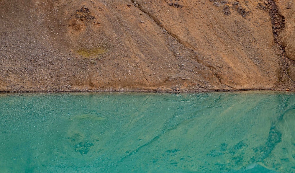 a body of water near a rocky cliff