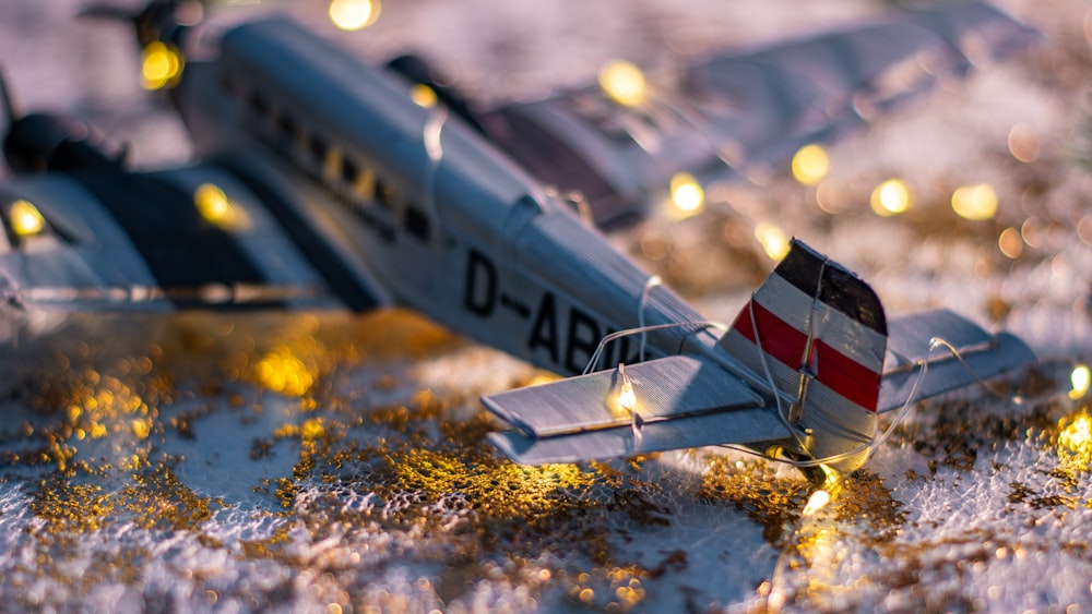 a model airplane is sitting on a snowy surface