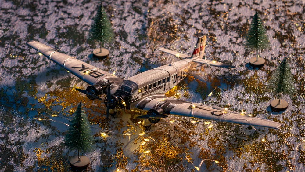 a model airplane is sitting on a snowy surface