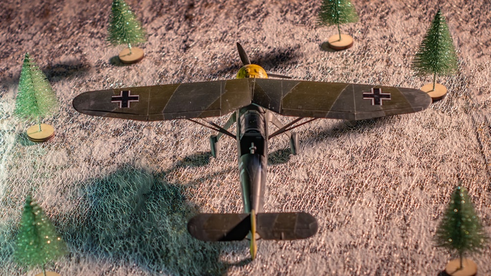 a model airplane with trees on the ground