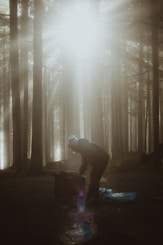 a man standing in the middle of a forest