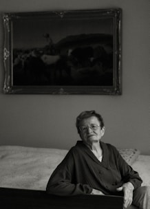 Clinician discussing prescription glasses options with an elderly patient at home.