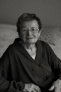 A calm elderly person wearing the Emotiv Insight headset during a cognitive training session at home.