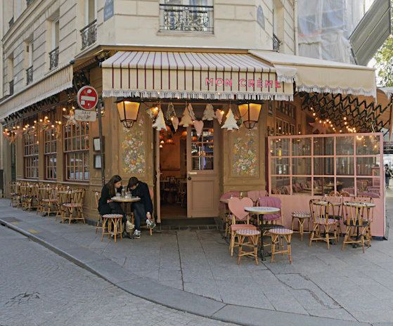 A charming street café with outdoor seating, where travelers share stories over coffee.
