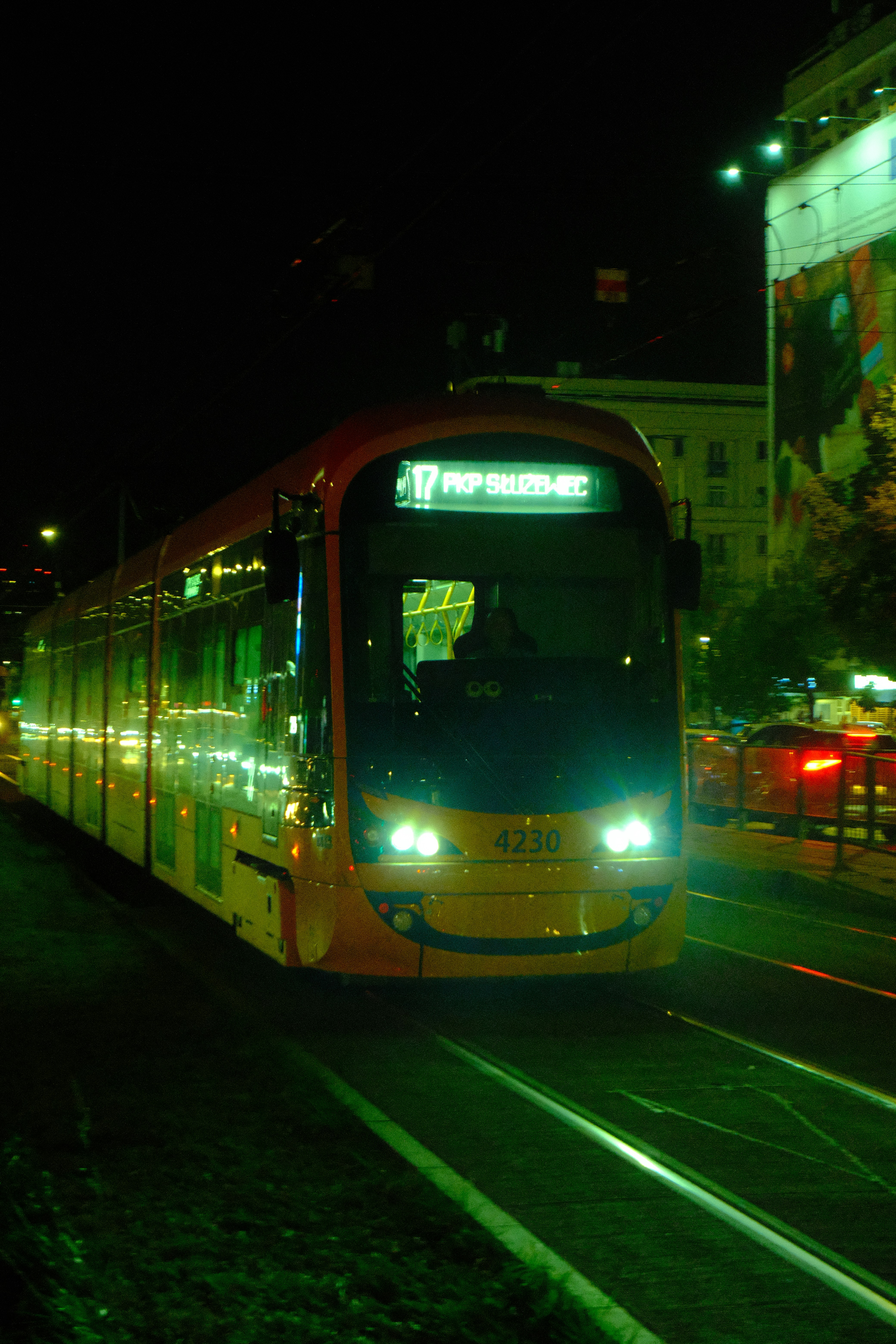 a city bus driving down a street at night