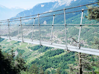 Suspension bridge stretching across lush green valleys at Mt. Daedunsan.