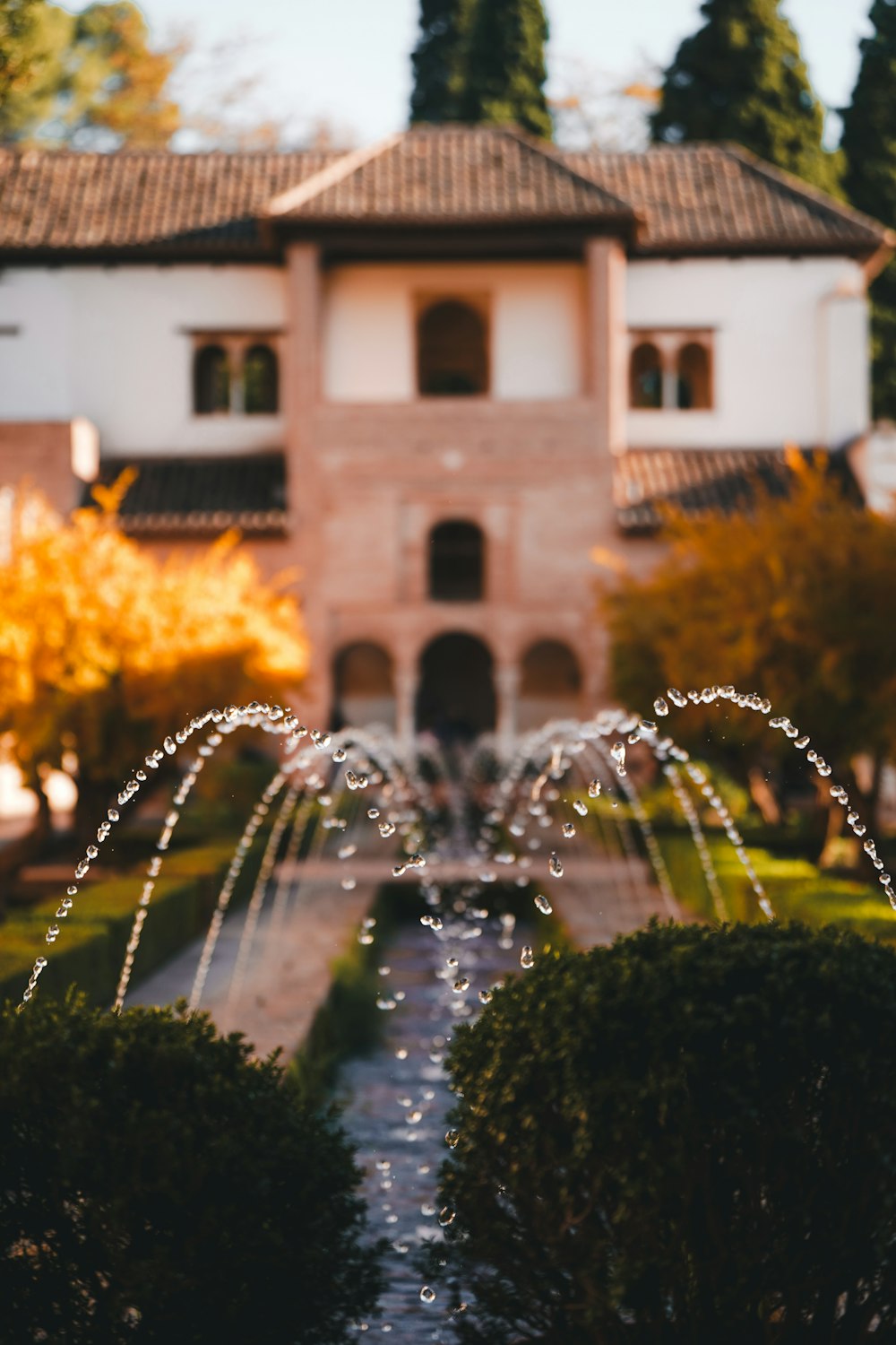 a water fountain in front of a house