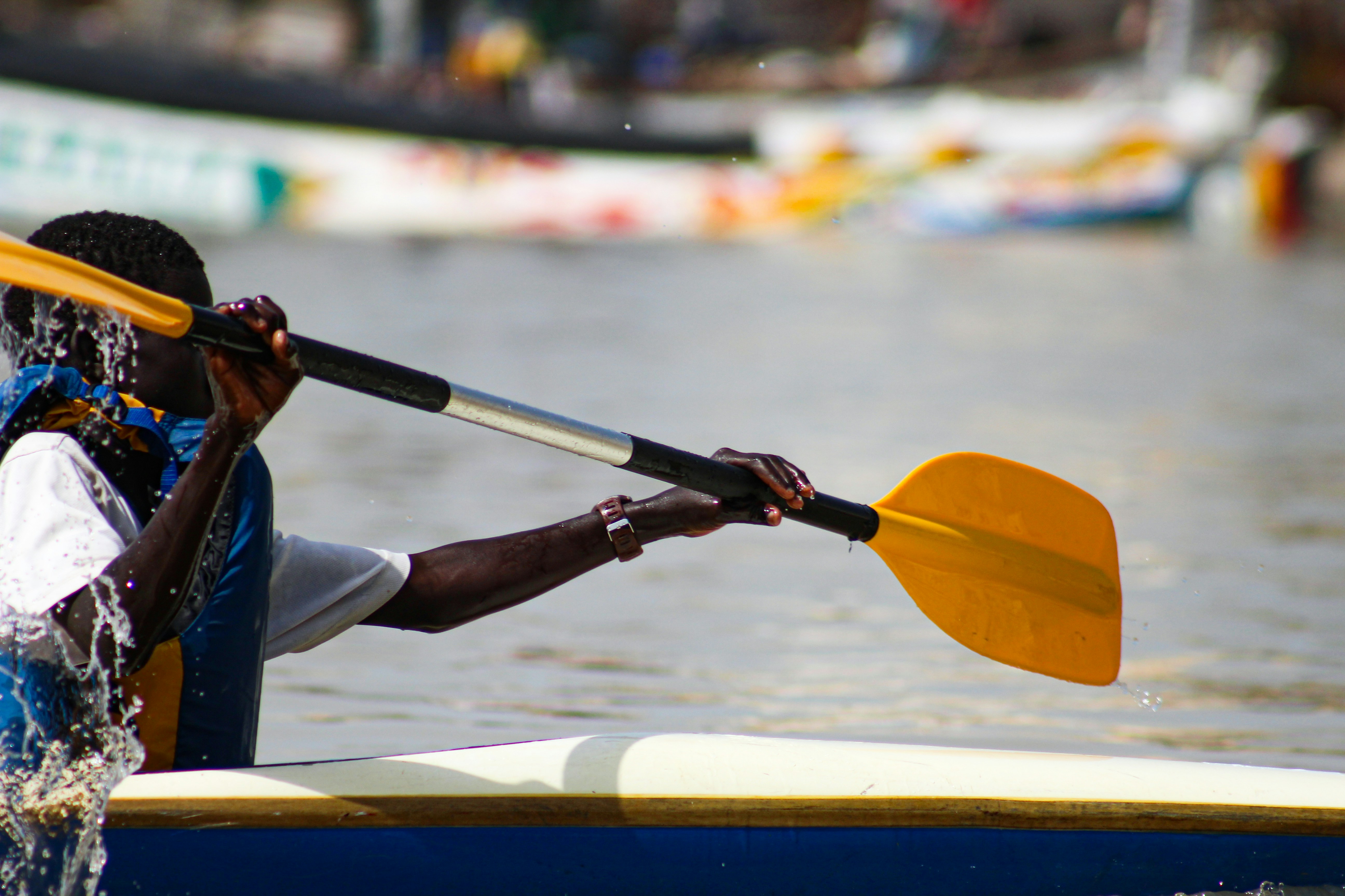 a man in a kayak paddling on the water