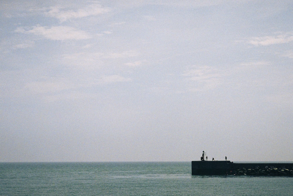 a small boat floating on top of a large body of water