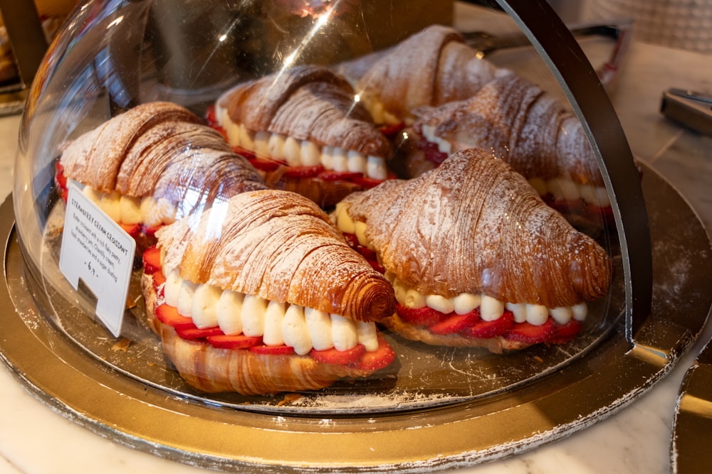 a display case filled with sandwiches covered in icing