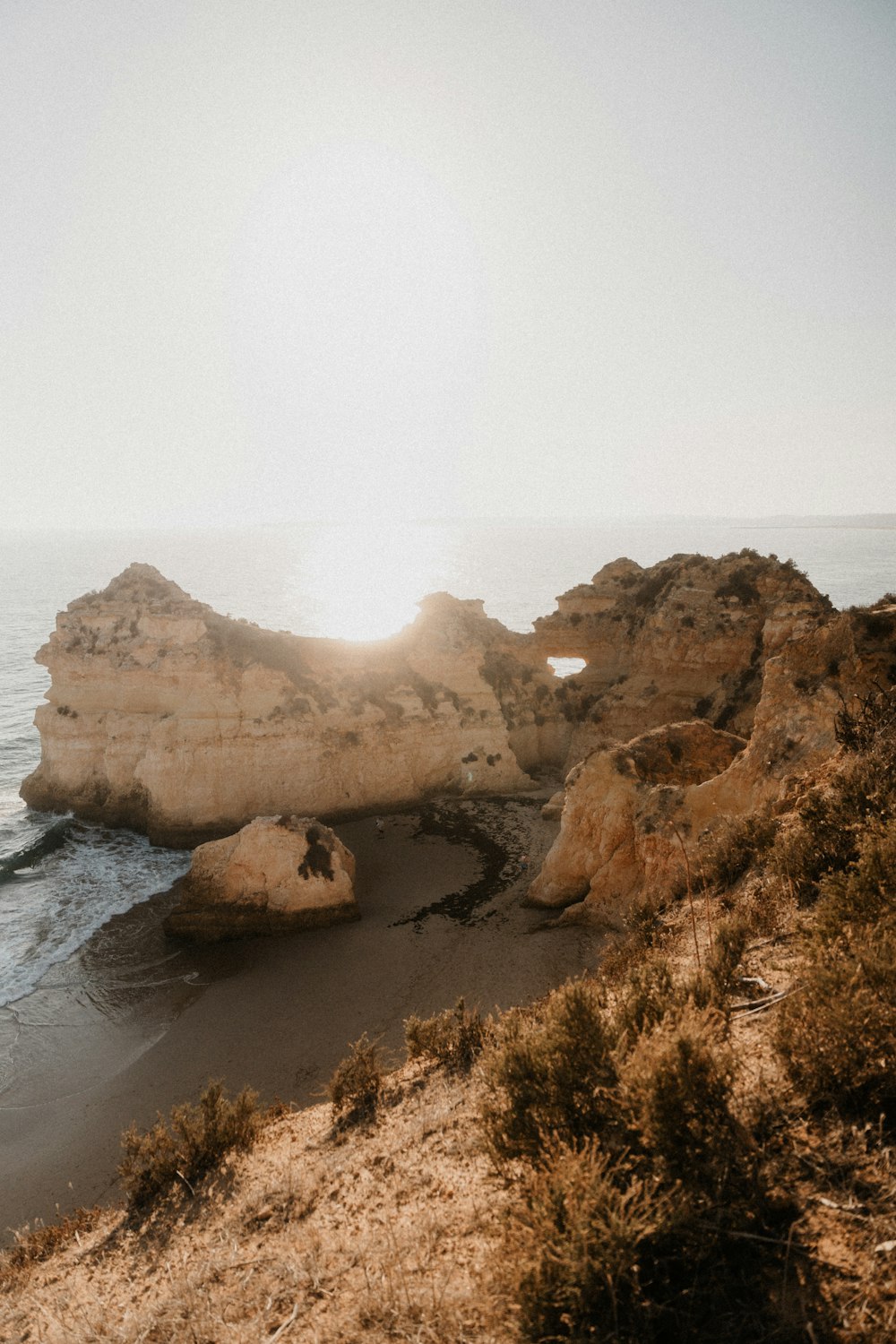 a large rock formation sitting on top of a beach