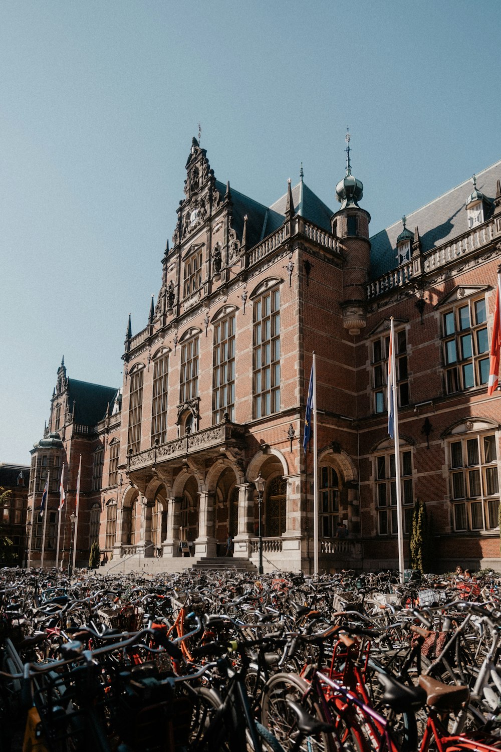 a large group of bicycles parked in front of a building