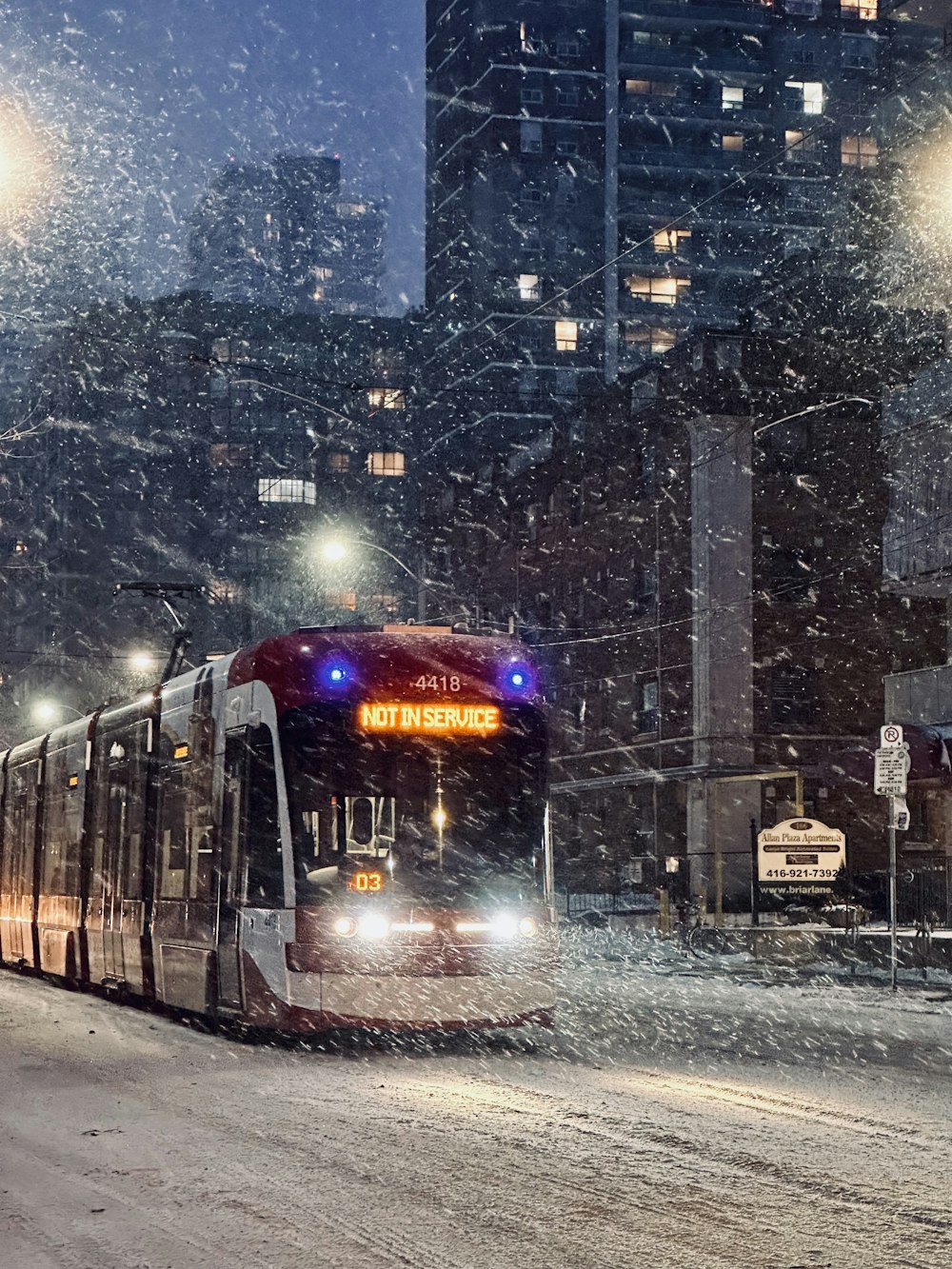 a city bus driving down a snowy street
