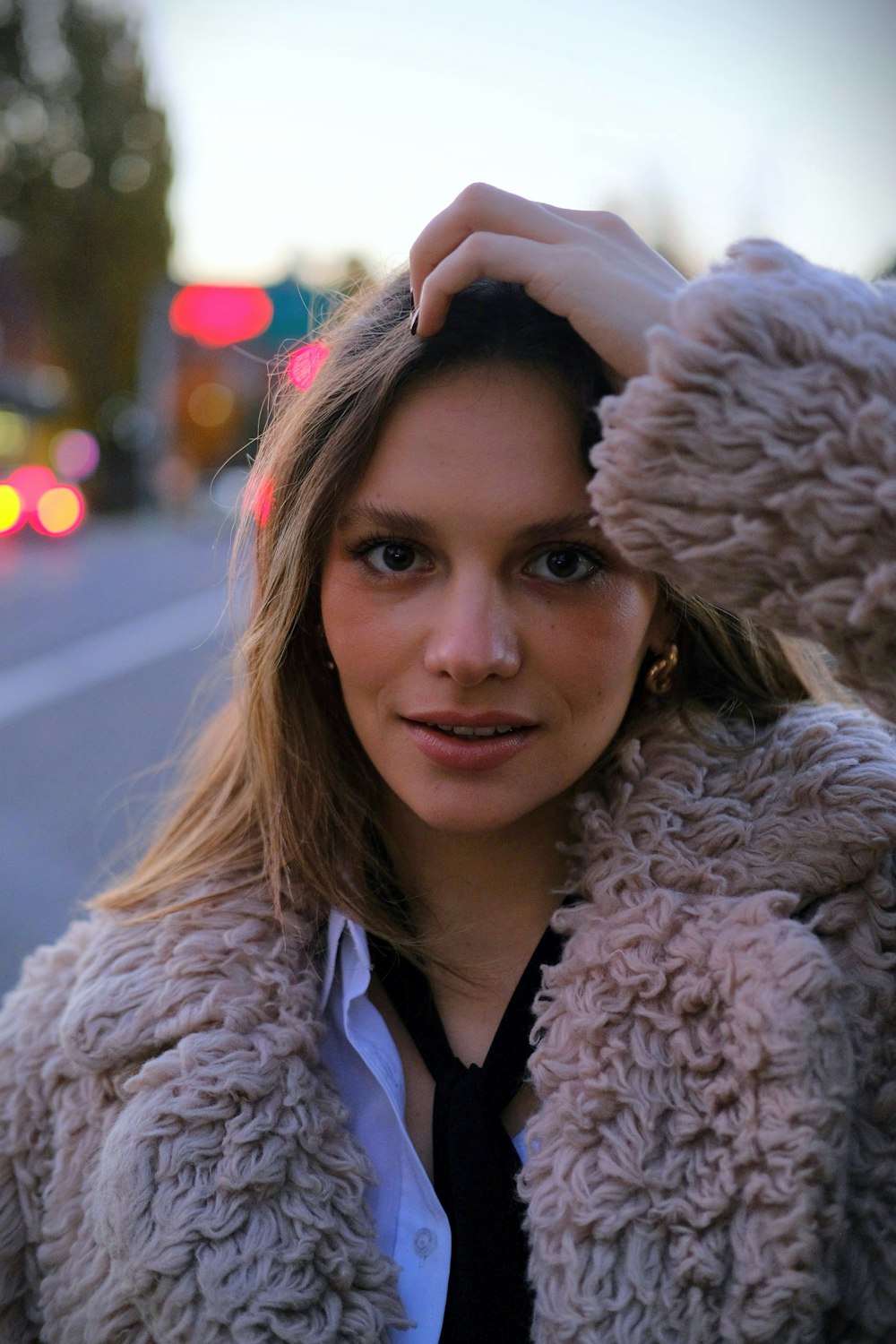 a woman in a furry coat posing for a picture