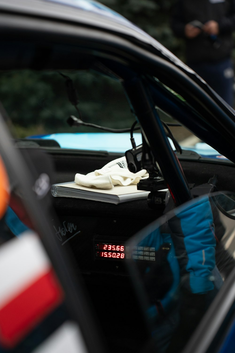 a pair of gloves sitting on top of a book in a car