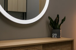 A smart LED mirror illuminating a stylish bathroom setting.