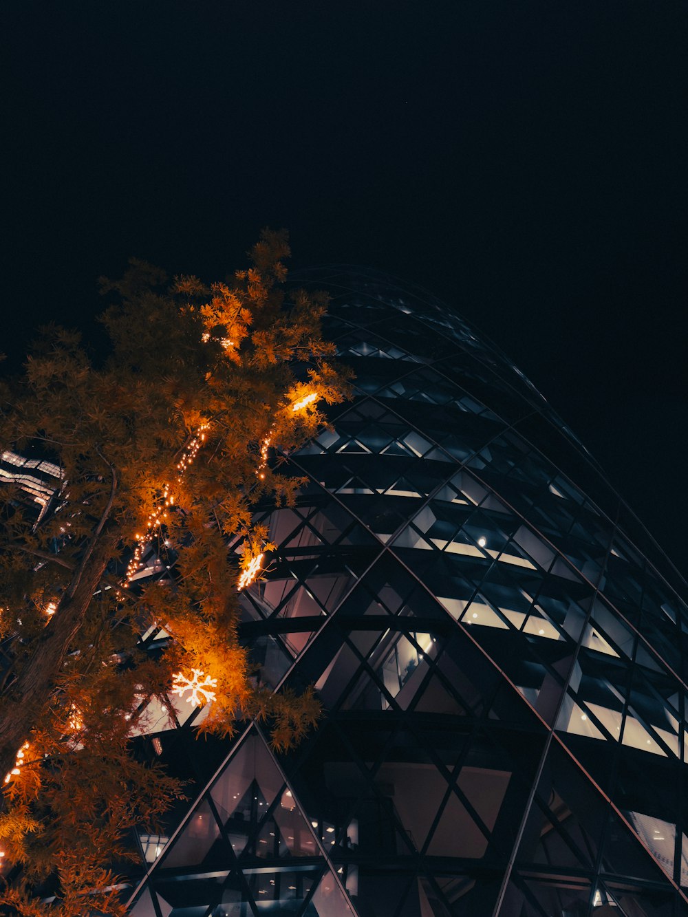 a very tall building with a tree in front of it