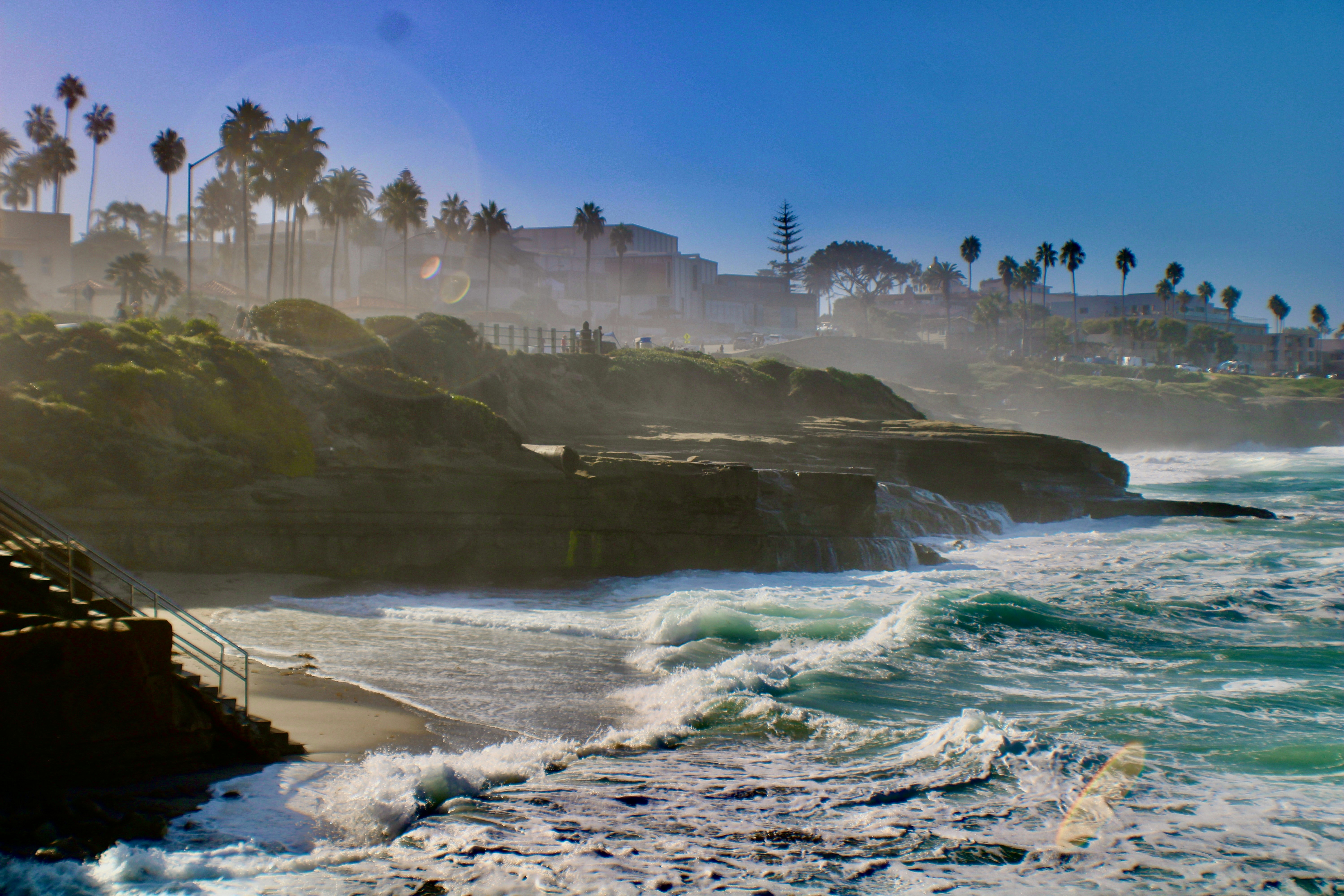 a view of a beach with waves crashing on the shore, Misty sea in at La Jolla.