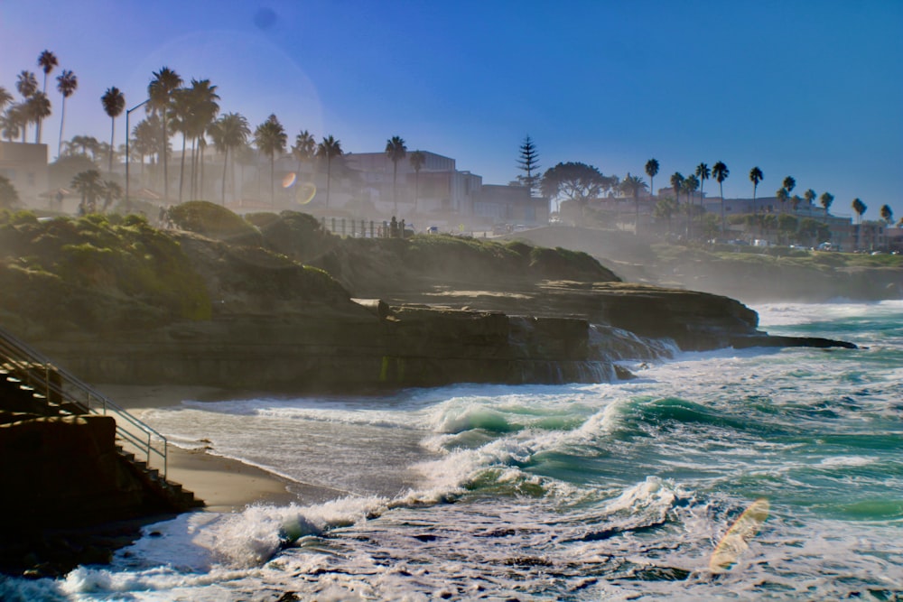 a view of a beach with waves crashing on the shore