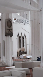 Comfortable seating area in the common space with minimalist decor and Mediterranean color accents.