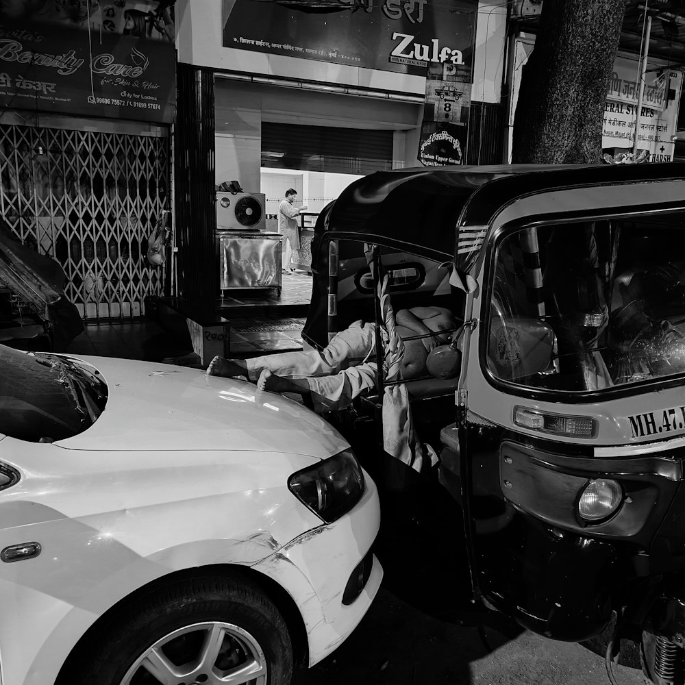 a black and white photo of a car and a truck