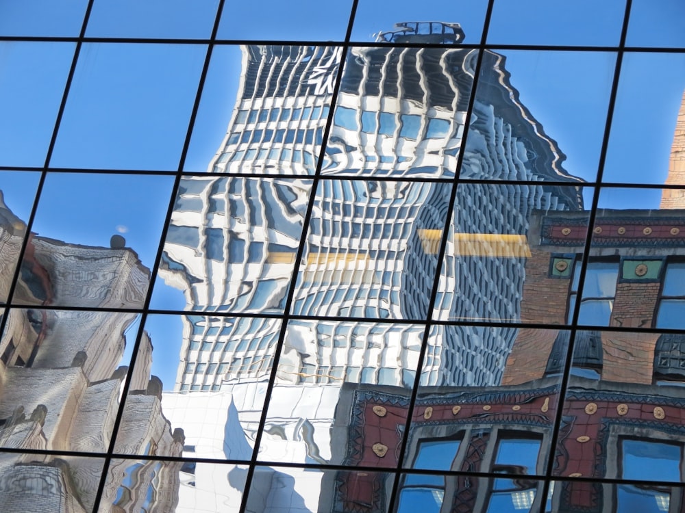 a reflection of a building in the glass of another building
