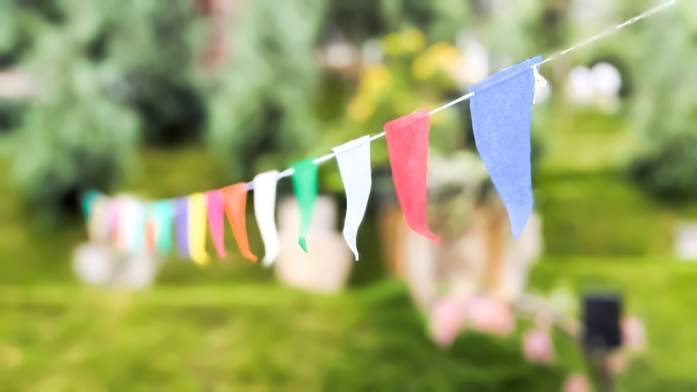 a bunch of colorful flags hanging from a line