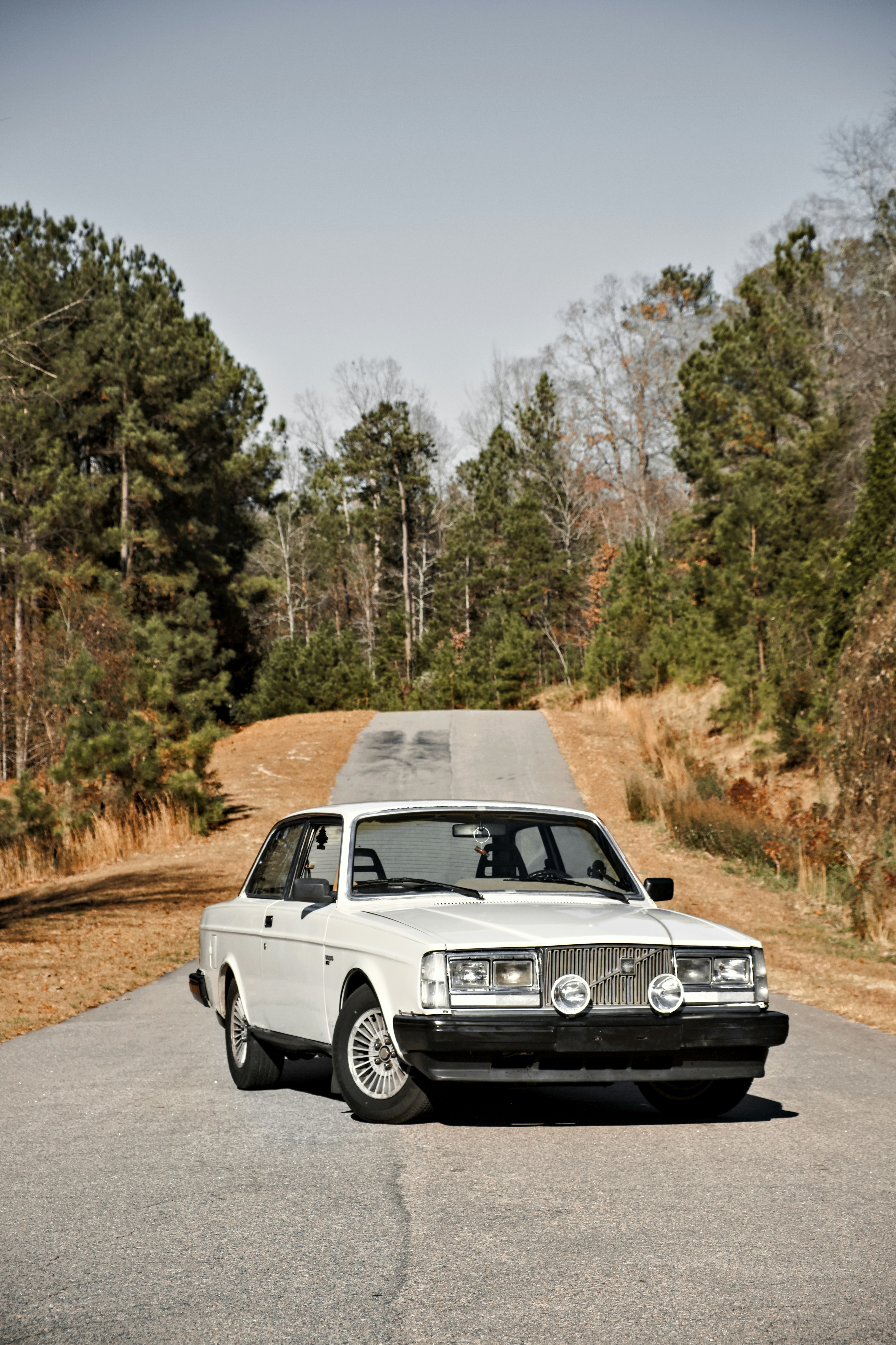 a white car parked on the side of a road