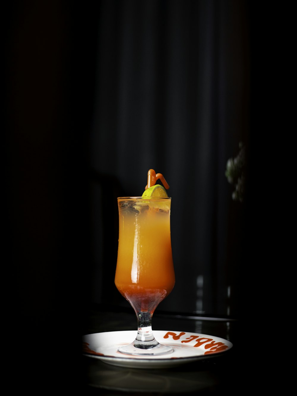 a glass filled with a drink sitting on top of a table