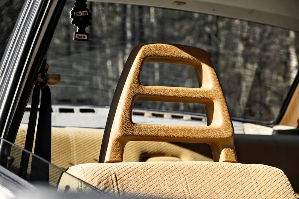 the interior of a car with a wooden seat