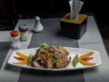 a white plate topped with meat and veggies