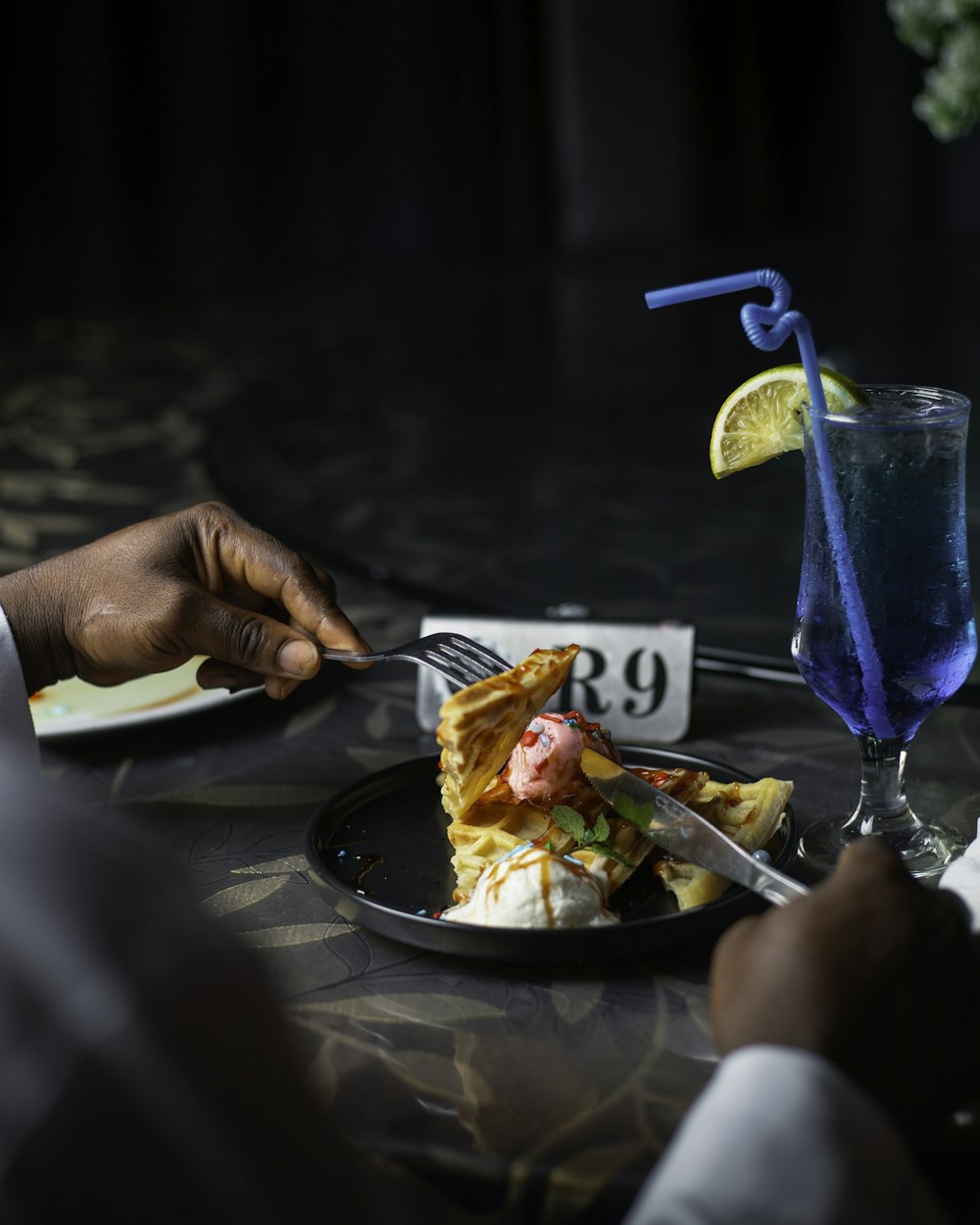 a plate of food and a drink on a table