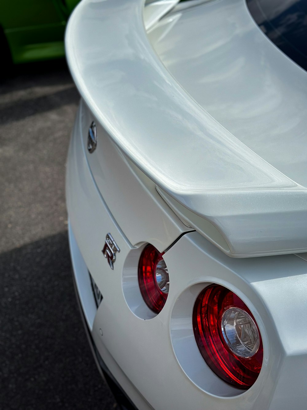 the tail lights of a white sports car