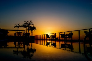 a couple of chairs sitting on top of a swimming pool
