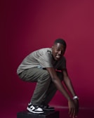 Trainer demonstrating proper form for squats on a split-screen video session