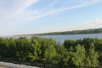 A panoramic view of the emerald-green Neretva River winding through Mostar with the iconic Old Bridge.