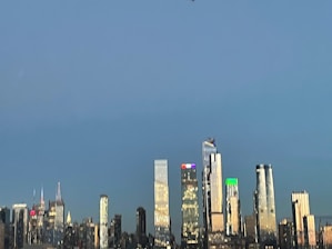 Modern city skyline at dusk with illuminated high-rise buildings reflecting a global investment vibe.