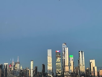 A high-resolution 3D render of a modern city skyline at dusk with glowing windows and reflective surfaces.