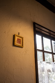 A beautiful framed photo hanging on a cozy living room wall.