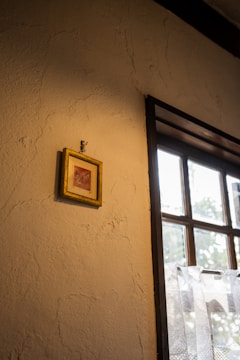 A close-up of a framed photo on a mantelpiece with soft lighting.