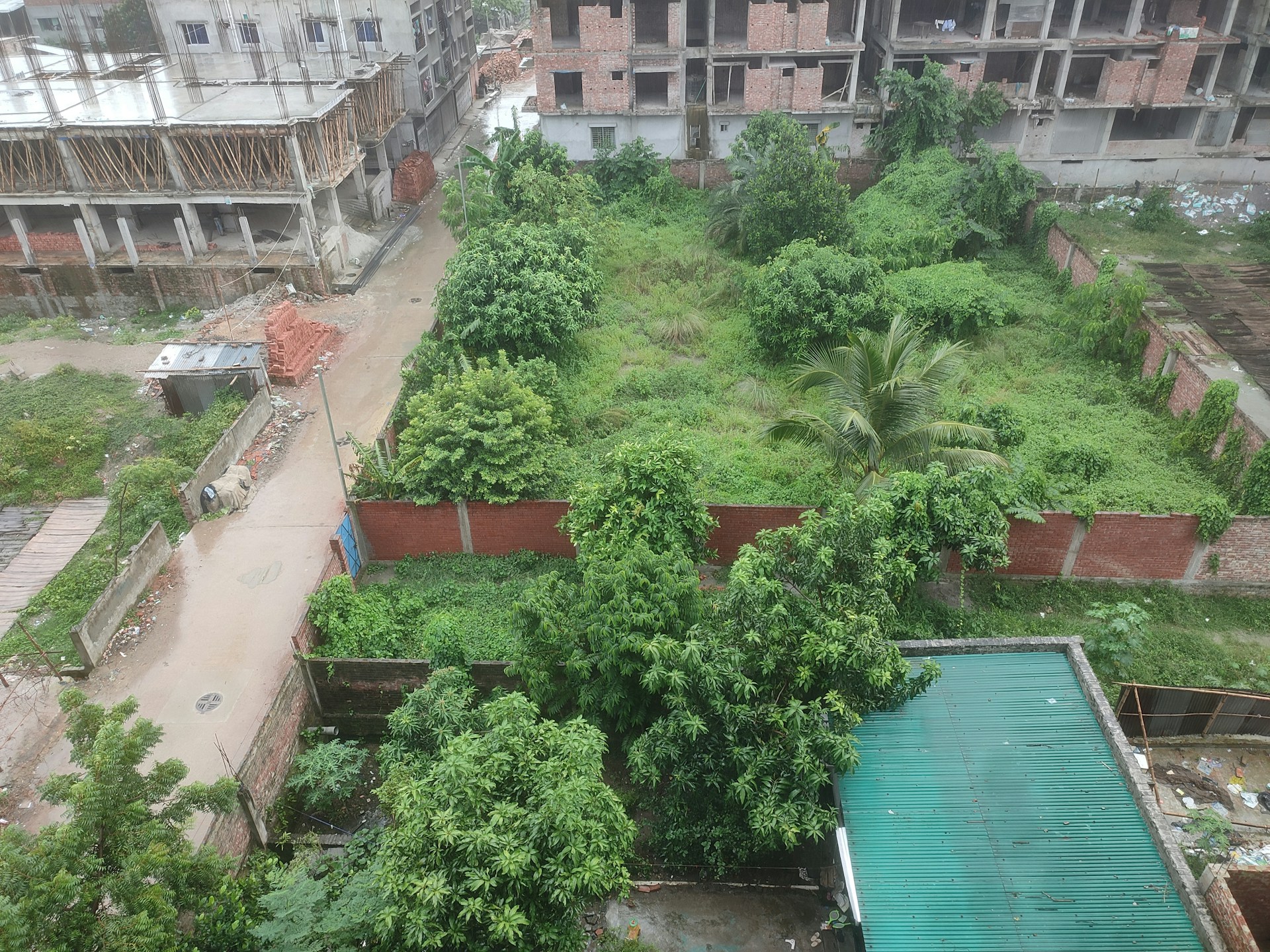 An open plot of land in Gurgaon ready for development, surrounded by urban infrastructure and greenery.