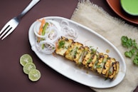 a white plate topped with food next to a fork