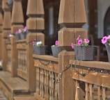 a wooden fence with flower pots on it