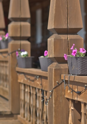 a wooden fence with flower pots on it