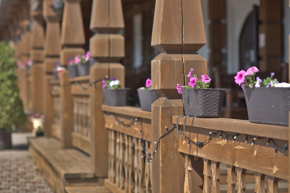 a wooden fence with flower pots on it